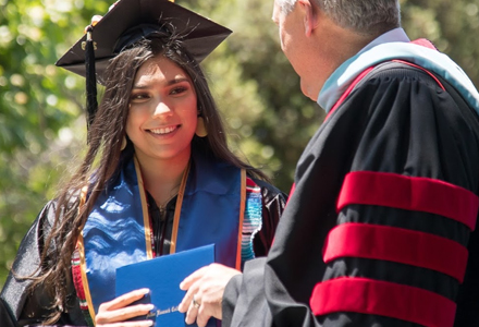 Woman graduating holding diploma
