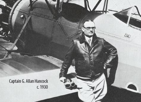 G. Allan Hancock standing next to an airplane 1930